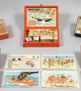 Cubes - Le Lotus Bleu Lombard, Fin 1940, Début 1950. Cubes Imprimés Sur Les 6 Cotés, Sous Boîte Luxe En Bois Peinte En Rouge Avec ... |  | Artcurial