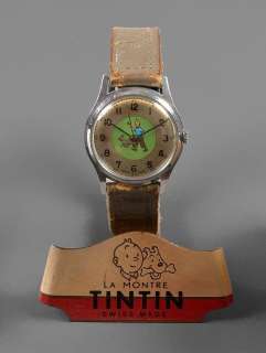 Montre Tintin Réalisée En Suisse Par Helva, Circa 1955. Illustrée de Tintin Et Milou En Pied Sur Fond Vert, Sur Le Cadran. Bracelet En |  | Artcurial